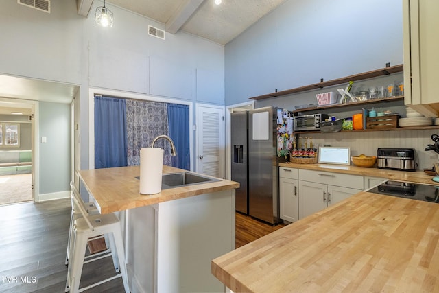 172 Dakota Rd, Bristol, VA 24201 - kitchen with butcher block countertops, high vaulted ceiling, stainless steel fridge with ice dispenser, dark wood-type flooring, and beamed ceiling