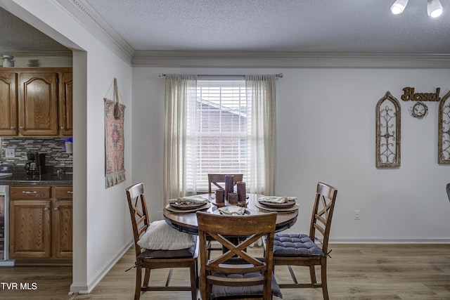 1905 Knob Creek Rd Unit 11, Johnson City, TN 37604 - dining space featuring ornamental molding, light wood finished floors, a textured ceiling, and beverage cooler