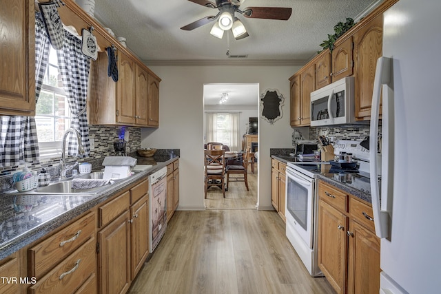 1905 Knob Creek Rd Unit 11, Johnson City, TN 37604 - kitchen with white appliances, backsplash, brown cabinetry, a ceiling fan, and a textured ceiling