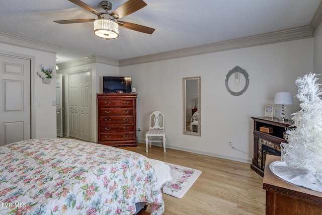 1905 Knob Creek Rd Unit 11, Johnson City, TN 37604 - bedroom featuring ornamental molding, light wood finished floors, a closet, a ceiling fan, and a fireplace
