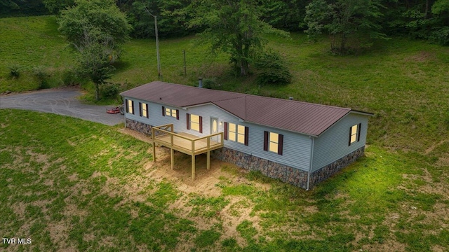 14450 Rattle Creek Rd, Abingdon, VA 24210 - rear view of house with metal roof, a wooden deck, asphalt driveway, and a lawn