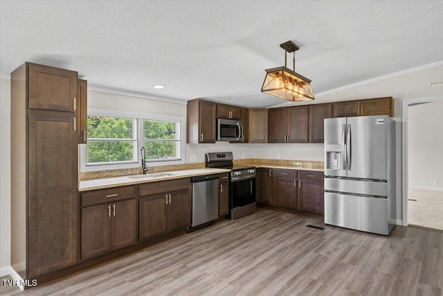 14450 Rattle Creek Rd, Abingdon, VA 24210 - kitchen featuring appliances with stainless steel finishes, a sink, light countertops, light wood-style floors, and a textured ceiling