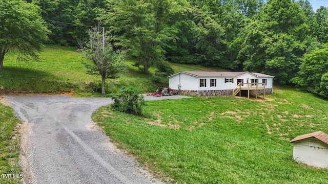 14450 Rattle Creek Rd, Abingdon, VA 24210 - manufactured / mobile home featuring driveway, a deck, stairway, a wooded view, and a front lawn