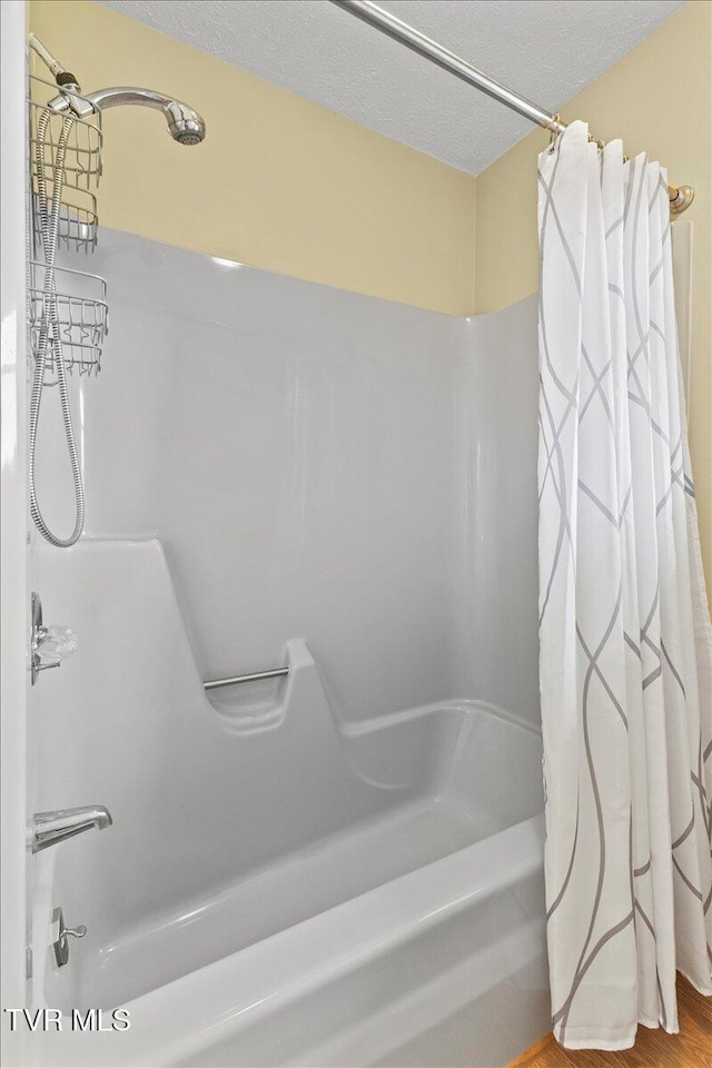 152 Ezee St, Elizabethton, TN 37643 - bathroom featuring shower / bath combination with curtain and a textured ceiling