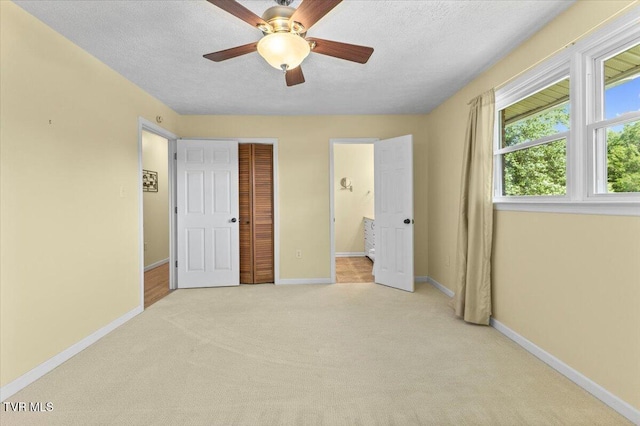 152 Ezee St, Elizabethton, TN 37643 - unfurnished bedroom with light colored carpet, a textured ceiling, ensuite bathroom, a closet, and a ceiling fan