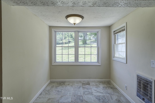 3912 Memorial Blvd, Kingsport, TN 37664 - unfurnished room featuring heating unit, healthy amount of natural light, and a textured ceiling
