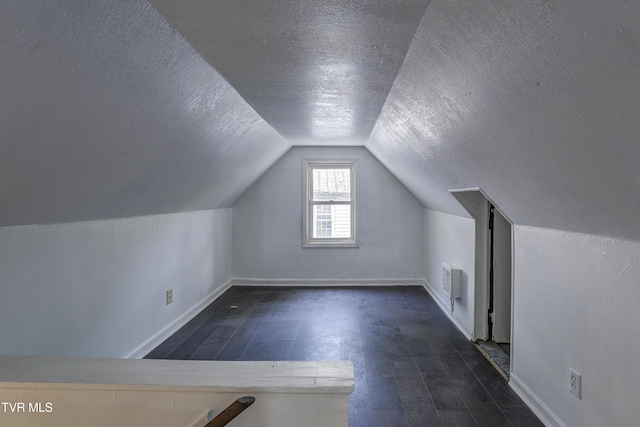 3912 Memorial Blvd, Kingsport, TN 37664 - bonus room with a textured ceiling, lofted ceiling, and dark wood-style flooring