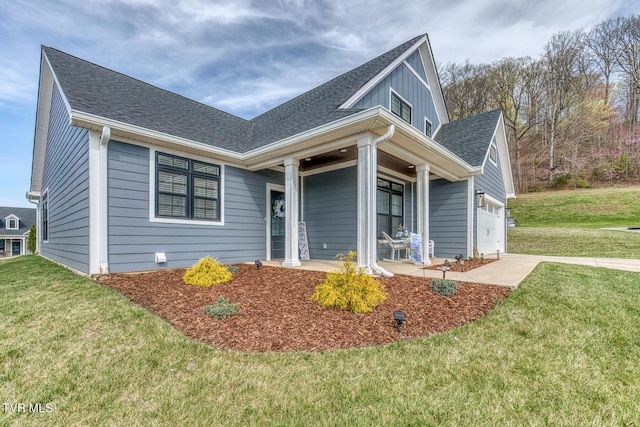85 Slonaker Cir, Jonesborough, TN 37659 - view of front facade with covered porch, a front lawn, board and batten siding, a shingled roof, and driveway