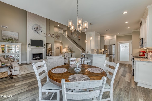 85 Slonaker Cir, Jonesborough, TN 37659 - dining area with light wood-type flooring, a chandelier, recessed lighting, ornamental molding, and a fireplace