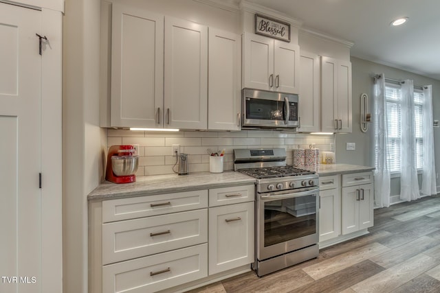85 Slonaker Cir, Jonesborough, TN 37659 - kitchen with appliances with stainless steel finishes, tasteful backsplash, recessed lighting, light wood finished floors, and white cabinets