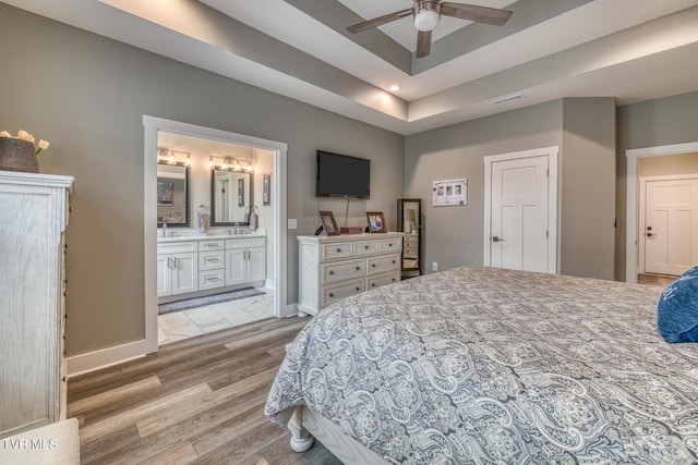 85 Slonaker Cir, Jonesborough, TN 37659 - bedroom featuring a tray ceiling, baseboards, light wood-style flooring, recessed lighting, and connected bathroom