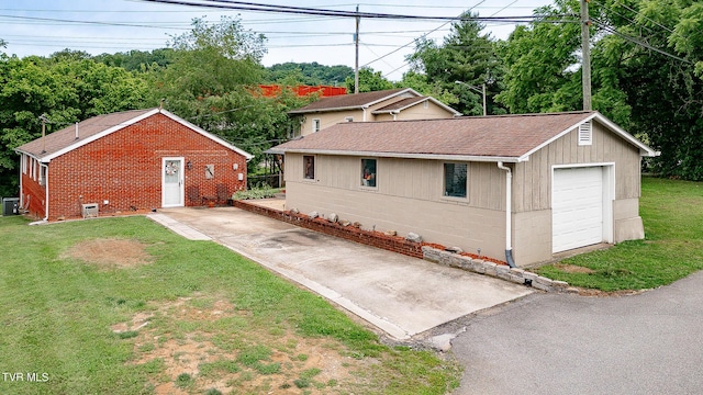 2009 Tenneva St, Kingsport, TN 37665 - view of property exterior with asphalt driveway, central AC unit, roof with shingles, a garage, and a lawn