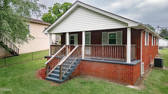 2009 Tenneva St, Kingsport, TN 37665 - view of front facade with central AC unit, a porch, and brick siding