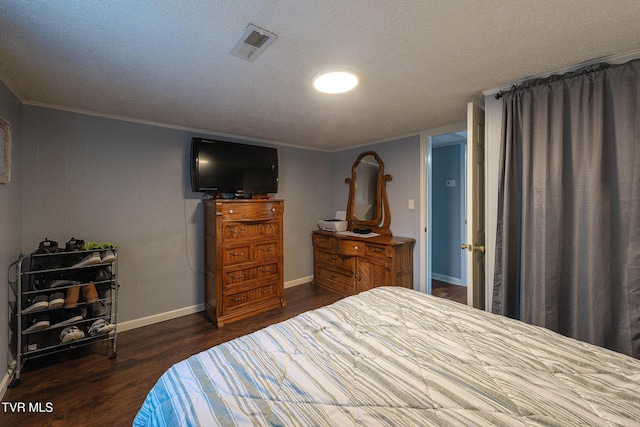 2009 Tenneva St, Kingsport, TN 37665 - bedroom with dark wood-style flooring, baseboards, ornamental molding, and a textured ceiling