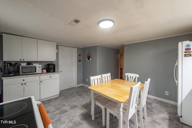 2009 Tenneva St, Kingsport, TN 37665 - dining room featuring baseboards, a textured ceiling, and crown molding