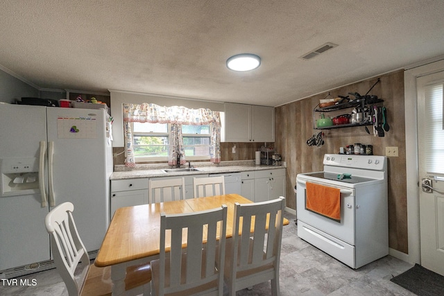 2009 Tenneva St, Kingsport, TN 37665 - kitchen featuring white appliances, a sink, light countertops, a textured ceiling, and white cabinets