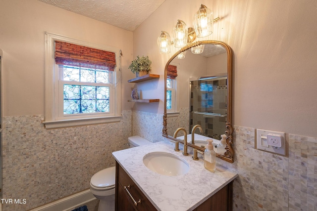 1024 Sharondale Ave, Kingsport, TN 37660 - bathroom featuring tile walls, toilet, vanity, wainscoting, and a shower with door