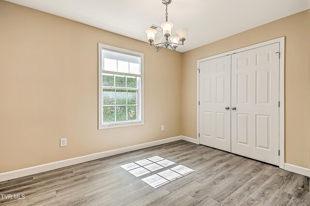 660 S Jena Beth Dr Unit 1, Elizabethton, TN 37643 - unfurnished bedroom with a chandelier, light wood finished floors, and a closet