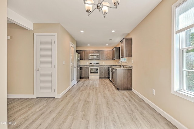 660 S Jena Beth Dr Unit 1, Elizabethton, TN 37643 - kitchen with stainless steel appliances, a chandelier, dark brown cabinetry, light countertops, and plenty of natural light