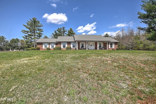 646 Meadow View Rd, Bristol, TN 37620 - view of front facade with a front lawn, metal roof, covered porch, and brick siding