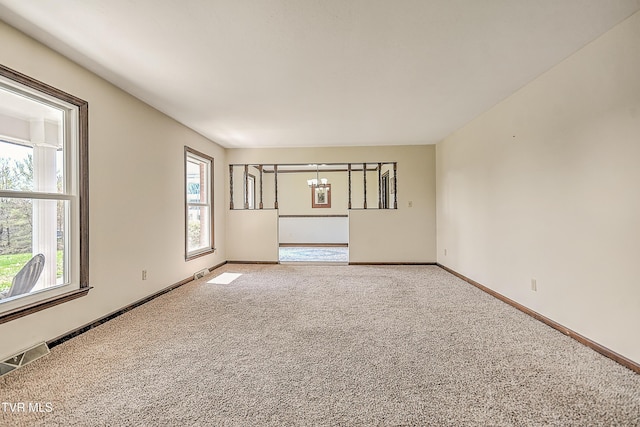 646 Meadow View Rd, Bristol, TN 37620 - unfurnished room featuring healthy amount of natural light, light carpet, and a chandelier