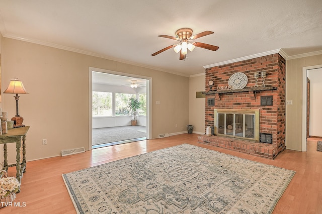 646 Meadow View Rd, Bristol, TN 37620 - living area featuring a ceiling fan, wood finished floors, a fireplace, crown molding, and baseboards