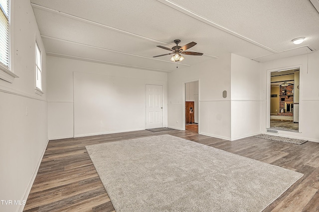 646 Meadow View Rd, Bristol, TN 37620 - unfurnished room with dark wood-type flooring, ceiling fan, a textured ceiling, baseboards, and attic access