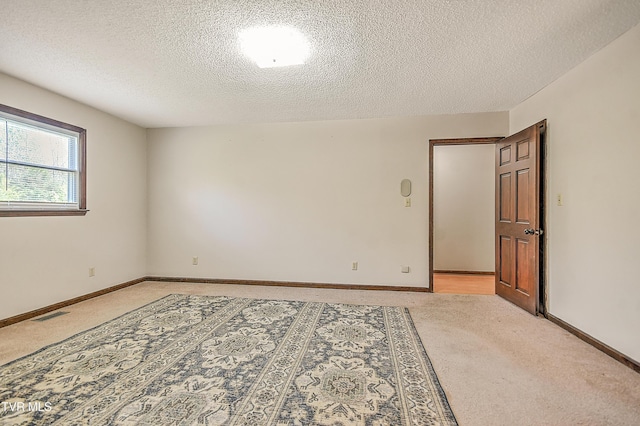 646 Meadow View Rd, Bristol, TN 37620 - spare room featuring light colored carpet, a textured ceiling, and baseboards