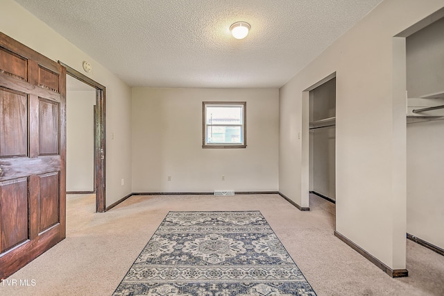 646 Meadow View Rd, Bristol, TN 37620 - unfurnished bedroom featuring light carpet, a textured ceiling, and baseboards