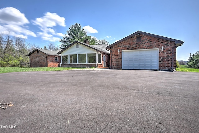 646 Meadow View Rd, Bristol, TN 37620 - ranch-style house featuring driveway, brick siding, a sunroom, a chimney, and a garage