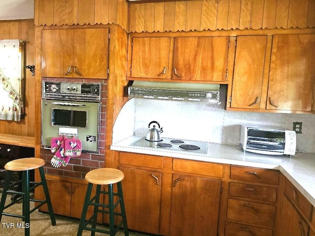 919 Coeburn Rd, Wise, VA 24293 - kitchen featuring oven, exhaust hood, electric cooktop, and brown cabinets
