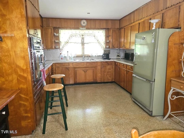 919 Coeburn Rd, Wise, VA 24293 - kitchen featuring freestanding refrigerator, brown cabinets, stainless steel oven, light countertops, and black microwave