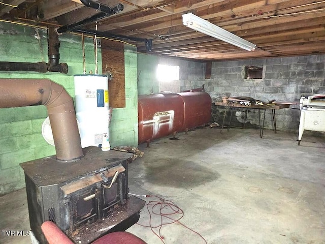 919 Coeburn Rd, Wise, VA 24293 - unfinished basement featuring water heater, a wood stove, and oil tank