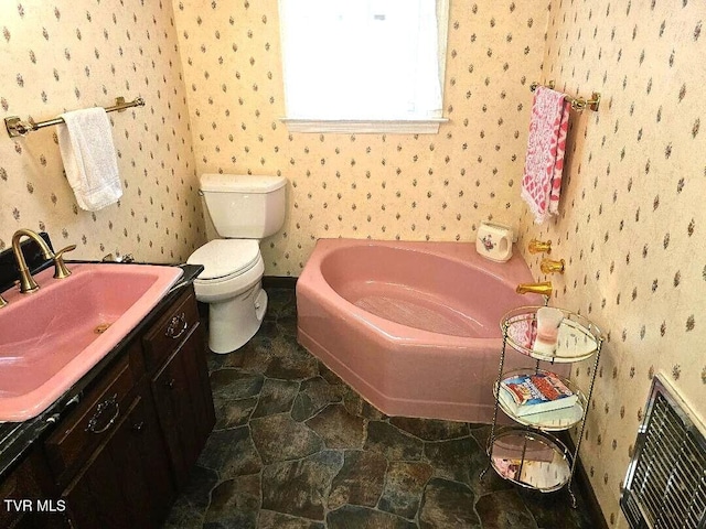 919 Coeburn Rd, Wise, VA 24293 - bathroom with a garden tub, vanity, wallpapered walls, and toilet