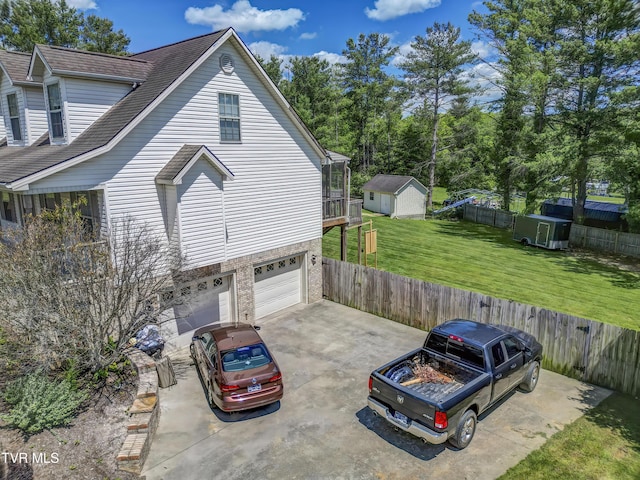 1032 Austin Ridge Ct, Piney Flats, TN 37686 - view of side of property featuring a storage shed, a garage, driveway, and roof with shingles