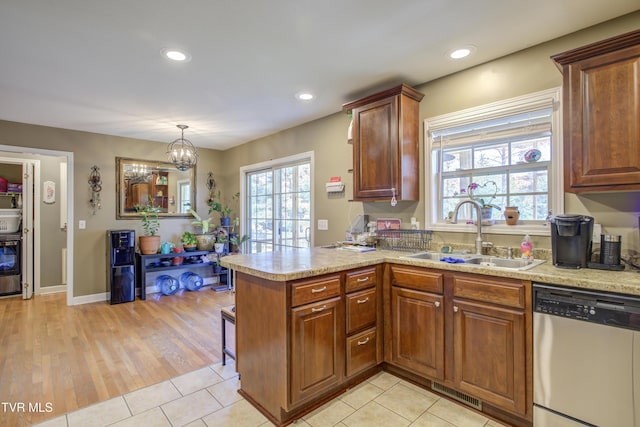 1032 Austin Ridge Ct, Piney Flats, TN 37686 - kitchen featuring stainless steel dishwasher, a peninsula, light countertops, brown cabinetry, and recessed lighting