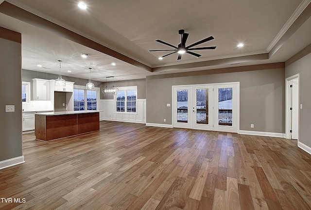 2406 Haystack Cir, Piney Flats, TN 37686 - unfurnished living room with a ceiling fan, a raised ceiling, recessed lighting, wood finished floors, and crown molding