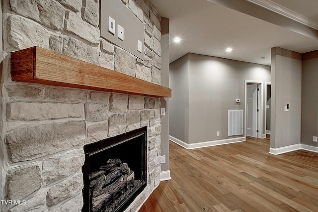 2406 Haystack Cir, Piney Flats, TN 37686 - unfurnished living room featuring wood finished floors, a stone fireplace, and recessed lighting