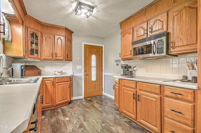 404 Stuffle St, Kingsport, TN 37660 - kitchen with stainless steel microwave, a textured ceiling, light countertops, black electric stovetop, and tasteful backsplash