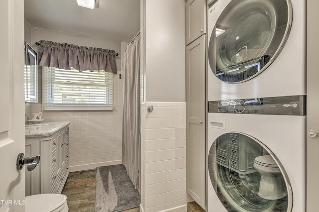 404 Stuffle St, Kingsport, TN 37660 - bathroom featuring estacked washer and dryer, tile walls, vanity, and a shower with curtain