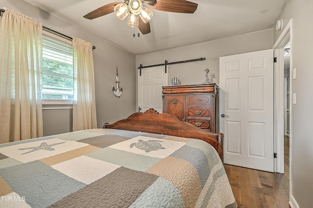 404 Stuffle St, Kingsport, TN 37660 - bedroom with hardwood / wood-style floors, a barn door, and ceiling fan