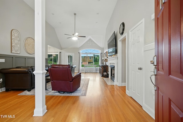 1844 Weaver Branch Rd, Piney Flats, TN 37686 - living area featuring ornate columns, a ceiling fan, light wood finished floors, a fireplace with flush hearth, and high vaulted ceiling