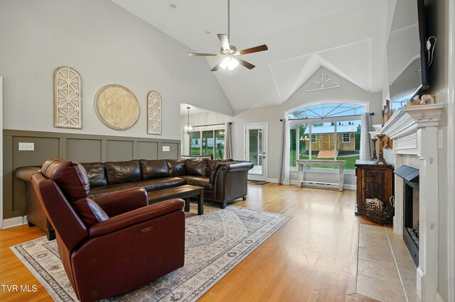 1844 Weaver Branch Rd, Piney Flats, TN 37686 - living area with high vaulted ceiling, a fireplace with flush hearth, ceiling fan, and light wood-style flooring