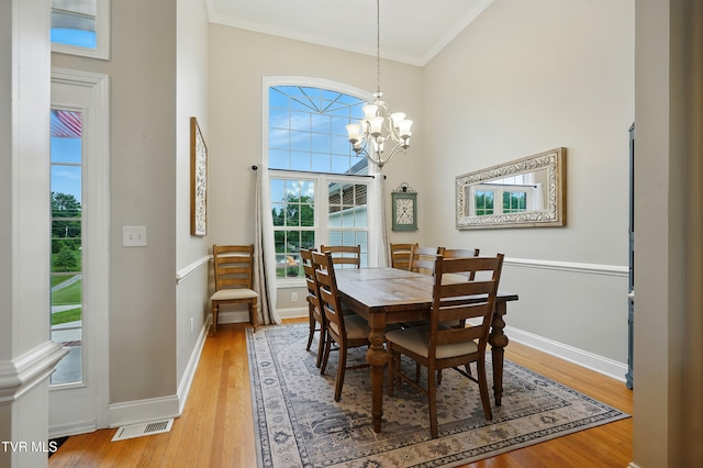 1844 Weaver Branch Rd, Piney Flats, TN 37686 - dining area featuring ornamental molding, light wood-type flooring, a chandelier, and a high ceiling