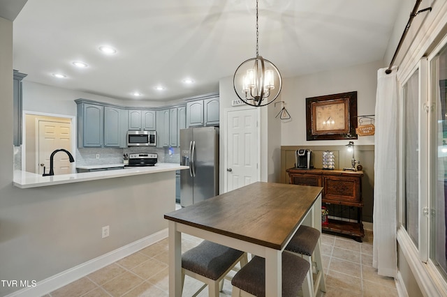 1844 Weaver Branch Rd, Piney Flats, TN 37686 - kitchen with stainless steel appliances, a chandelier, light countertops, tasteful backsplash, and light tile patterned flooring