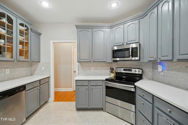1844 Weaver Branch Rd, Piney Flats, TN 37686 - kitchen featuring stainless steel appliances, gray cabinets, light tile patterned floors, glass insert cabinets, and recessed lighting