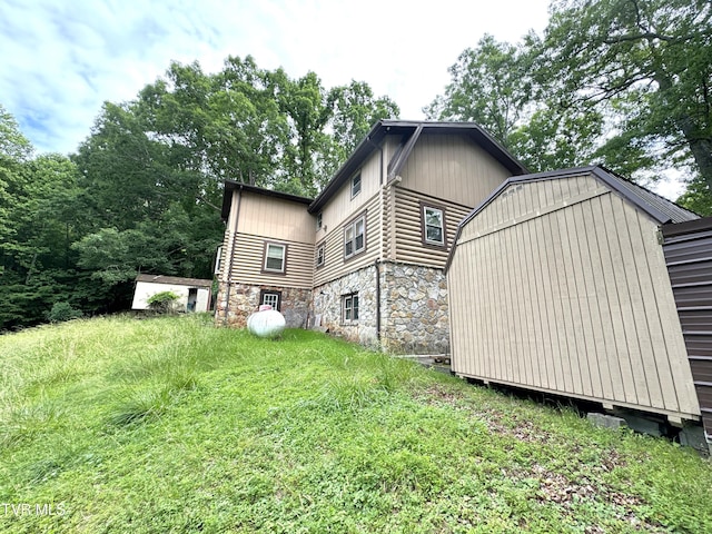 2401 Egan Rd, Big Stone Gap, VA 24219 - view of side of home with stone siding, a storage shed, and log exterior