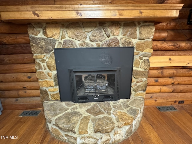 2401 Egan Rd, Big Stone Gap, VA 24219 - detailed view of wood finished floors, log walls, and a fireplace
