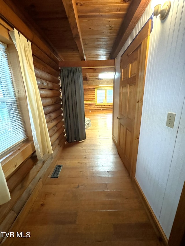 2401 Egan Rd, Big Stone Gap, VA 24219 - hallway featuring a wood ceiling with exposed beams, light wood finished floors, rustic walls, and wooden walls