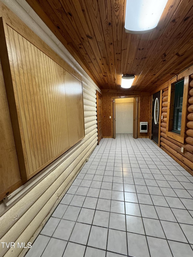 2401 Egan Rd, Big Stone Gap, VA 24219 - empty room featuring rustic walls, wooden ceiling, heating unit, and light tile patterned flooring